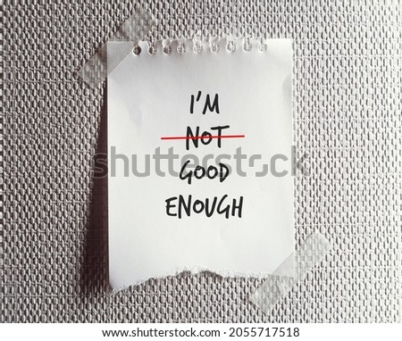 Torn note paper written I AM NOT GOOD ENOUGH , change to I AM GOOD ENOUGH , concept pf self improvement by boosting self esteem and change negative inner perception to be positive one Royalty-Free Stock Photo #2055717518