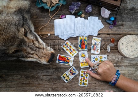 Fortune telling on tarot cards, witch hand is opening cards, used Marseille Tarot deck by unknown artist published first in 1709 Royalty-Free Stock Photo #2055718832