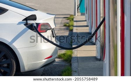 Electric car on charging spot - Car sharing commuter charging station