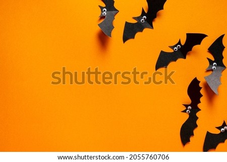 Paper bats on an orange background