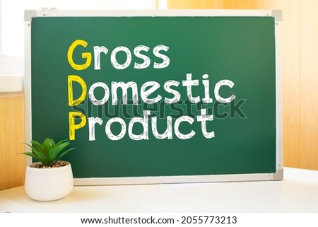 gdp in chalk on the school board, Search engine optimization and websites. Desk, swept balls of paper, computer keyboard