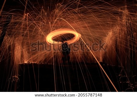 Long exposure shots of lit steel wool giving off sparks in a cave