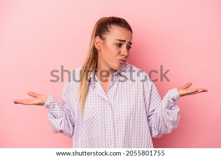 Young Russian woman isolated on pink background keeping a secret or asking for silence.