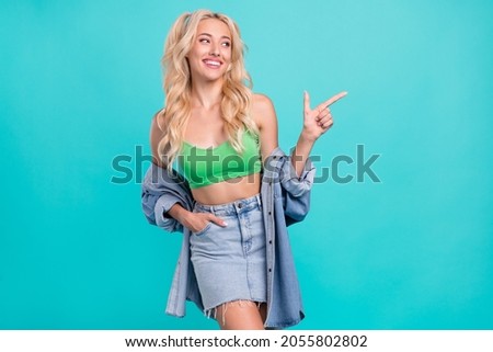Photo of young dreamy nice positive woman point finger look empty space news isolated on blue color background