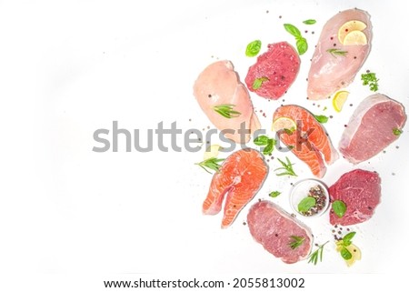 Various natural food, high animal protein sources - pork, beef meat steaks, chicken breast fillet, eggs, salmon fish on white table background top view copy space  Royalty-Free Stock Photo #2055813002