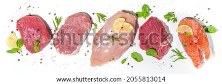 Various natural food, high animal protein sources - pork, beef meat steaks, chicken breast fillet, eggs, salmon fish on white table background top view copy space  Royalty-Free Stock Photo #2055813014