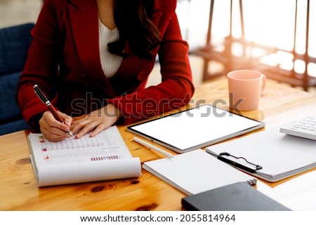 Businesswoman hands hold documents with financial statistic stock photo,discussion and analysis data the charts and graphs. Finance concept