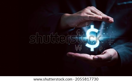 Businessman hand protecting USD dollar sign and other currency sign such as pound yen and Euro for technology currency exchange and money transfer concept.