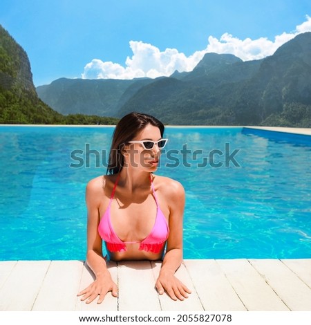 Beautiful woman in outdoor swimming pool at luxury resort and beautiful view of mountains on sunny day