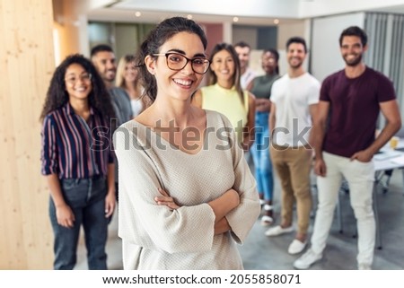 Shot of successful business team posing for presentation of work while looking at camera in a coworking space. Royalty-Free Stock Photo #2055858071