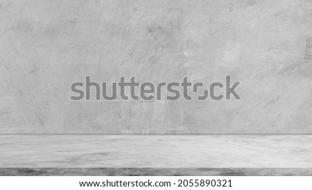 Empty gray cement wall room and floor interiors studio background, well editing montage display advertising stage products and text present on free space concrete backdrop   
