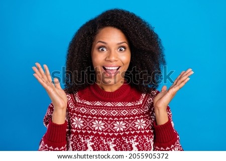 Photo of charming excited lady wear print pullover rising arms smiling isolated blue color background