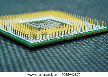 Macro photo of computer or laptop CPU microprocessor processor. Close-up of metallic gold pins and green PCB of computer processor. Semiconductors, pins and connectors. Selective focus.  Royalty-Free Stock Photo #2055942872