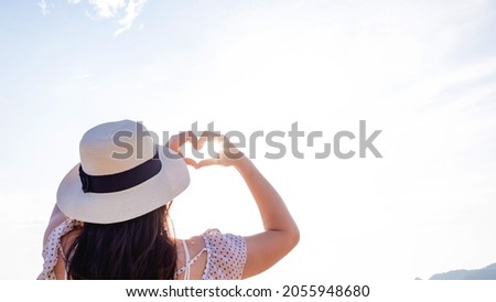 Valentine day., Love shape hands at beach., blue sky background., Copy space. 