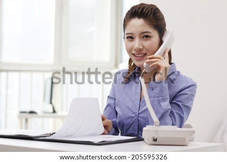 	Businesswoman using a smart-phone,reading	