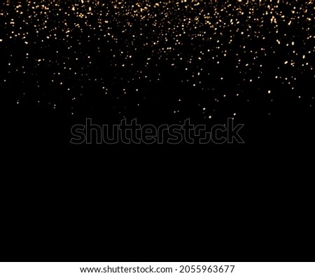 Golden falling sparkles on black background