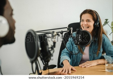 Woman recording podcast with black man