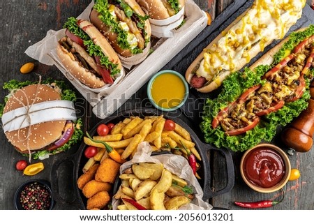 American fast food. Hamburgers, French fries, hot dogs. fast food and unhealthy eating concept. top view.