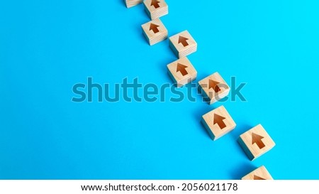Chain of arrows blocks. Consistency and focus. Concept of conformism, vertical of power. Unchanging course of development. Moving forward. Step by step process. Education and skill growth. Royalty-Free Stock Photo #2056021178