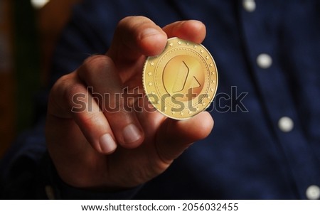 Avalanche AVAX cryptocurrency symbol golden coin in hand abstract concept. Royalty-Free Stock Photo #2056032455