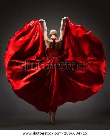 Ballerina Dancing in Red Flying Dress Rear Back Side View. Graceful Woman Ballet Performer in Flamenco Skirt. Expressive Passion Dance in Motion over Dark Background Royalty-Free Stock Photo #2056034915
