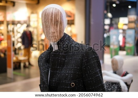 Mannequins in clothes on the background of shopping center stores