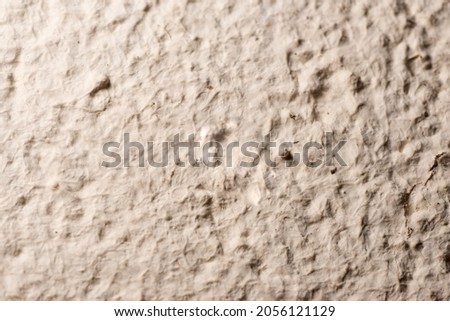 Background texture of rough exterior wall painted beige.