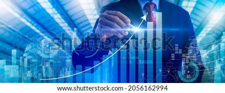 Businessman point to growthing graph and modern computer virtual dashboard analyzing finance sales data and economic growth graph chart and block chain technology. Royalty-Free Stock Photo #2056162994