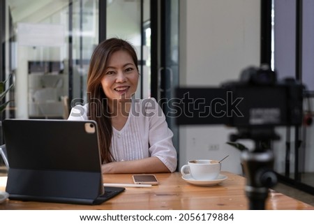 Business woman or blogger recording vlog on digital camera and live stream.