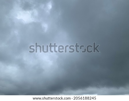 Dramatic landscape of stormy sky Nimbostratus Clouds A gray Style rolls and Huge scary storm it's going to rain heavily.no focus Royalty-Free Stock Photo #2056188245