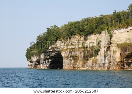 Kayakers paddling in a cave under the cliffs of Pictured Rocks National Lakeshore of Lake Superior, Munising, Michigan, USA