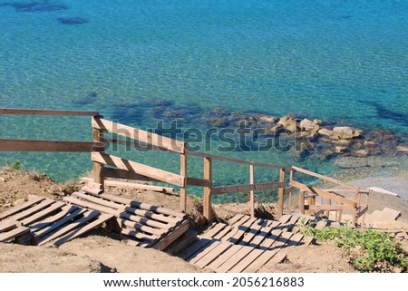 Wooden stairs to the beach. Picture is taken at Cape Drastis, a beautiful spot on the North Coast of Corfu, a Greek island in the Ionan Sea.