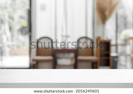 Empty wooden desk with blurred background of cafe or restaurant. For present products.