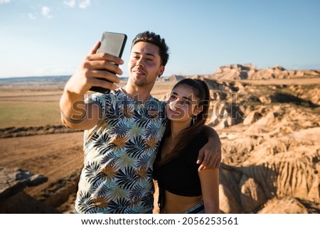 Young caucasian couple taking a selfie at Bardenas Reales, Navarra, Basque Country.