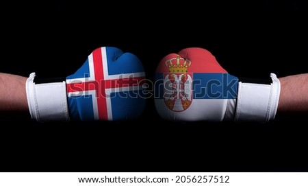 Two hands of wearing boxing gloves with Serbia and Iceland flag. Boxing competition concept. Confrontation between two countries