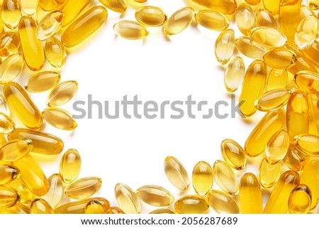 Frame made of fish oil capsules on white background