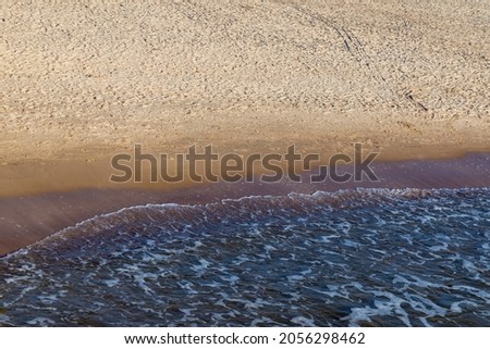 Soft wave of the sea on the sandy beach.Soft focus,blurred image.Copy space.