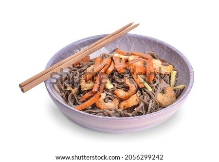 Plate with tasty soba noodles and shrimps on white background