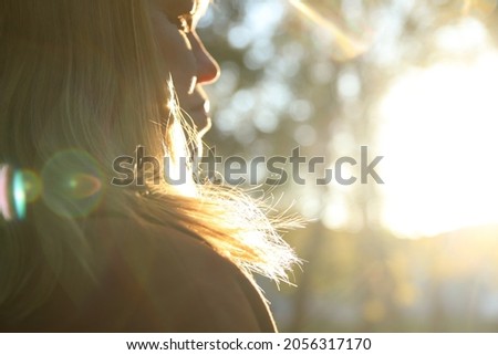 Close-up silhouette of woman looking at sunrise. Mental health, hope, happiness concept. Dream autumn. Peace lifestyle. Open mind, new goals and decisions. Sunlight in fall park or forest. Royalty-Free Stock Photo #2056317170