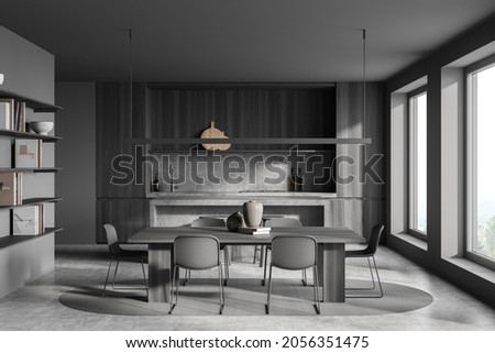 Dark kitchen room interior with two barstools, bar counter, dining table with six chair, cupboard, shelves with books, concrete floor and panoramic window. Contemporary minimalist design. 3d rendering