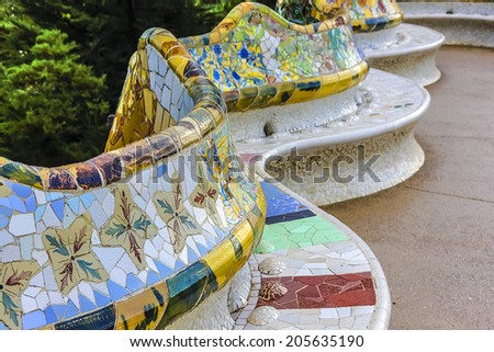 Colorful ceramic bench in Park Guell. Park Guell (1914) is the famous architectural town art designed by Antoni Gaudi. Barcelona, Spain.