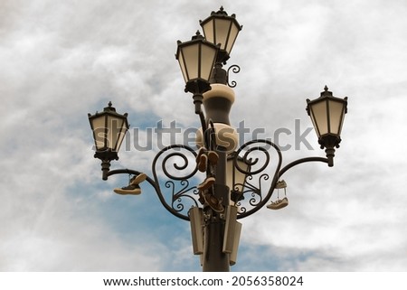 Picture of chandelier on cloudy day with the shoes on top