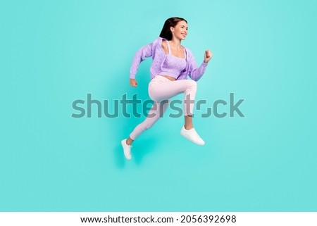 Profile photo of sportive active lady jump run empty space wear purple cardigan isolated teal color background