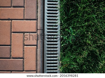 stone tiles, metal gutters, green lawn