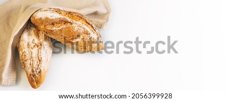 Banner fresh homemade bread with sunflower seeds, carrots isolated on a white background, cotton towel. Side view, top view, close-up view