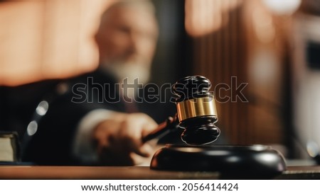 Court of Law and Justice Trial Session: Imparcial Honorable Judge Pronouncing Sentence, striking Gavel. Focus on Mallet, Hammer. Cinematic Shot of Dramatic Not Guilty Verdict. Close-up Shot. Royalty-Free Stock Photo #2056414424