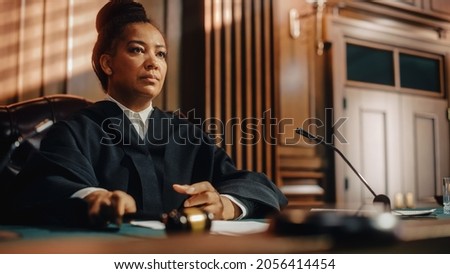 Court of Law Trial in Session: Portrait of Honorable Female Judge Reading Decision. Presiding Justice Pronouncing Sentence. Not Guilty Verdict Judgment. Royalty-Free Stock Photo #2056414454