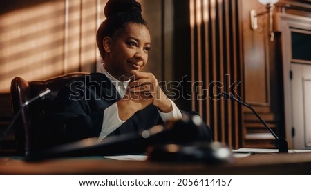 Cinematic Court of Law Trial: Humane Portrait of Impartial Smiling Female Judge Listening Happily to Jury's Verdict. Wise, Incorruptible, Fair Justice Imprisoning Criminals and Protecting The Innocent Royalty-Free Stock Photo #2056414457