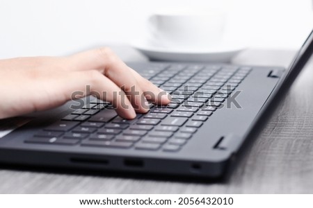 Man's hand typing on laptop.