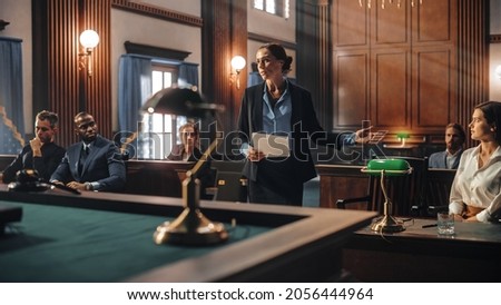 Court of Justice and Law Trial: Female Public Defender Presenting Case, Making Passionate Speech to Judge, Jury. Multiethnic Attorney Lawyer Protecting Client's Innocents with Supporting Argument. Royalty-Free Stock Photo #2056444964